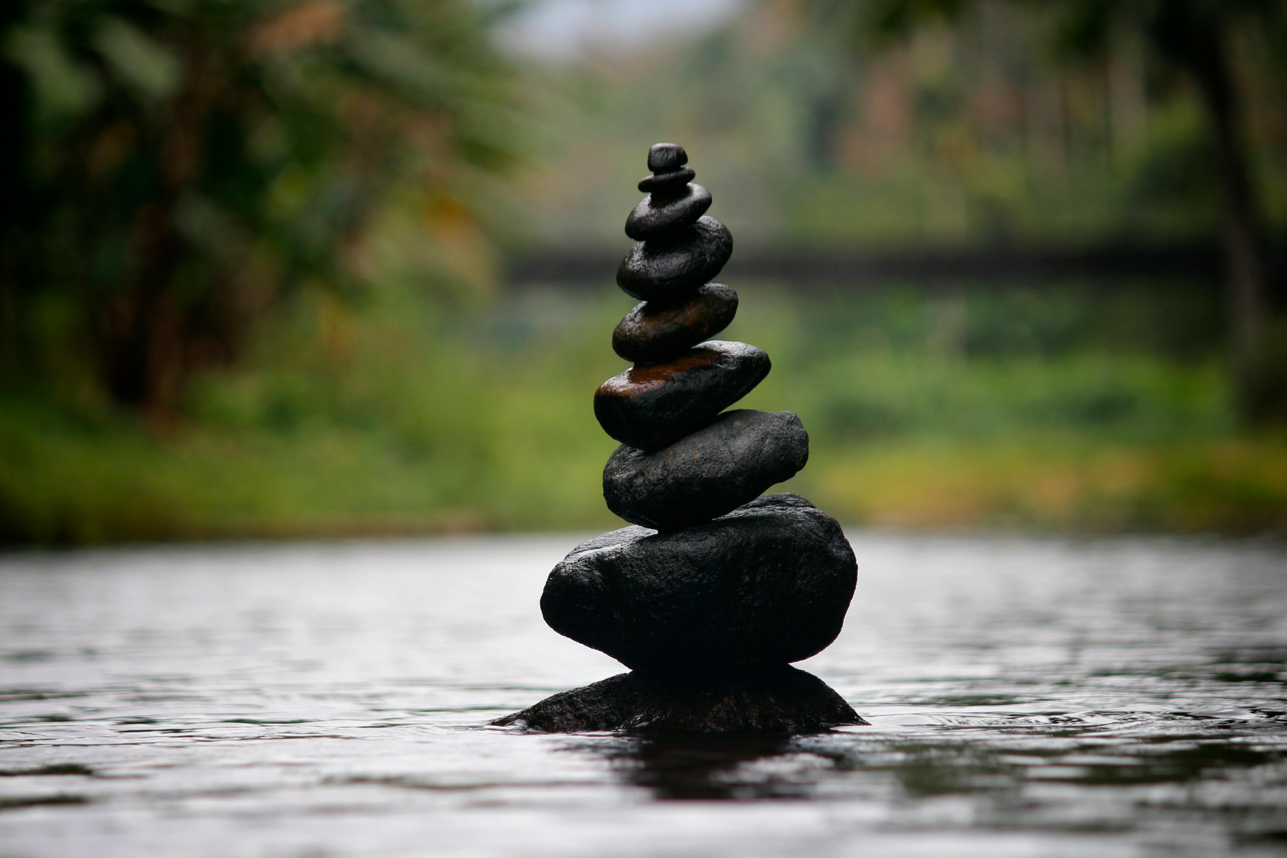 Rocks stacked in the middle of a pond